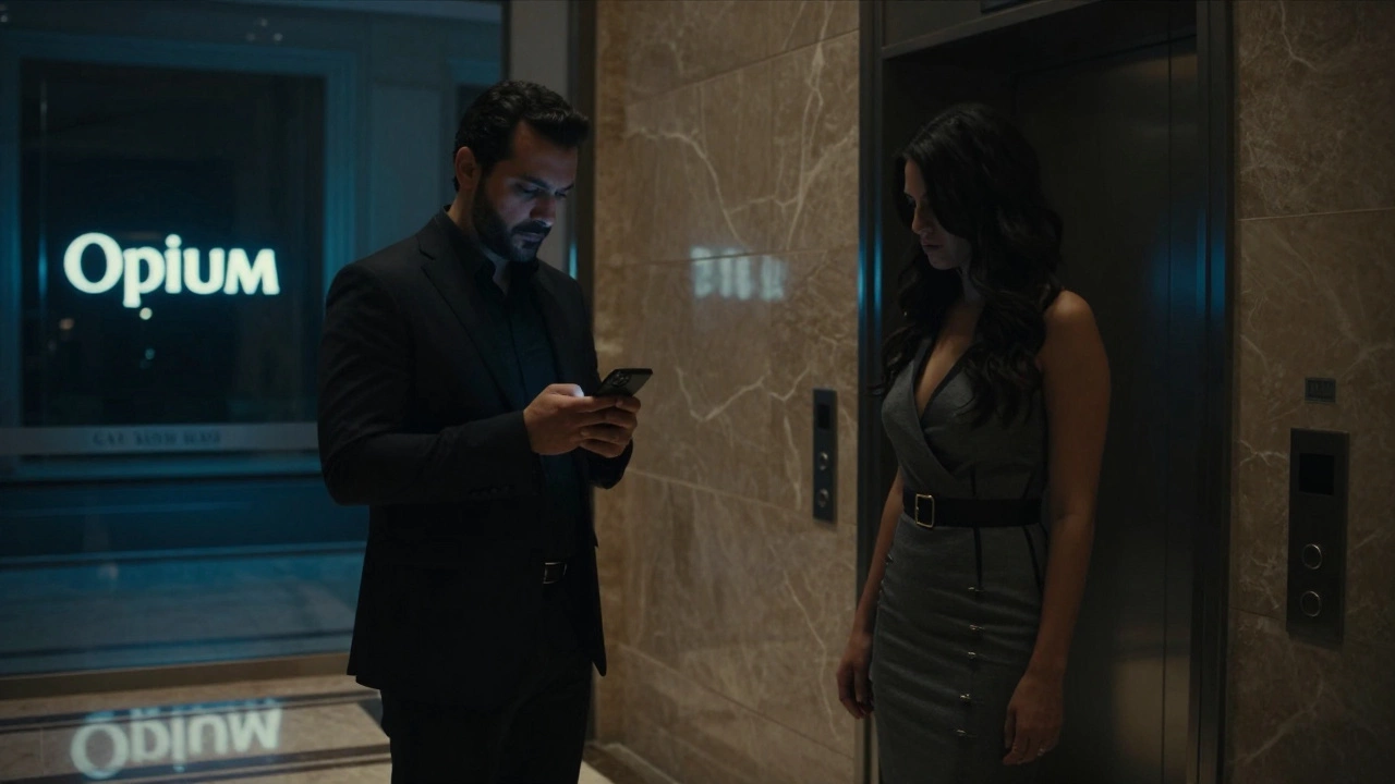 A man and woman in a luxury hotel lobby, one glancing at a phone, the other partially hidden in shadow.